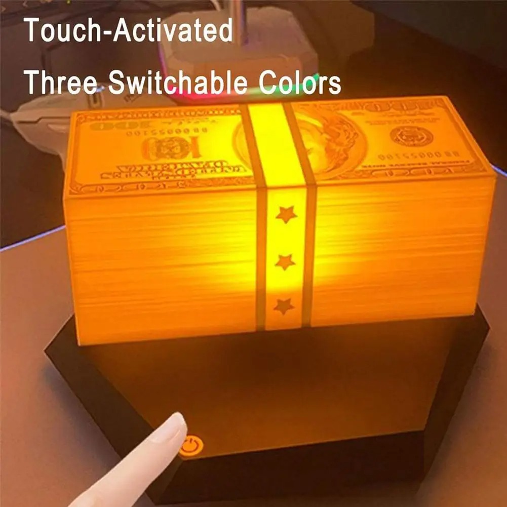 Warm amber lamp glow reflected across a dark desk surface